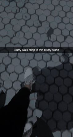 a person standing on a tiled floor with the words blurry walk snap in this blurry world