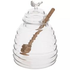 a glass jar with a wooden stick sticking out of it