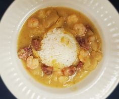 a white plate topped with shrimp and rice