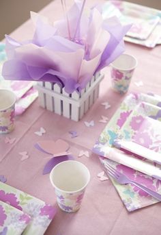 the table is set with paper napkins and cups