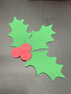 the paper holly has been cut out to look like leaves