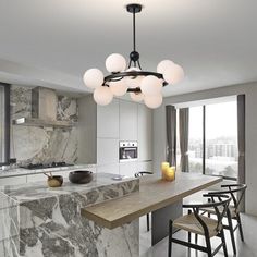 a modern kitchen with marble counter tops and an island