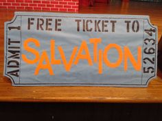 a ticket to salvation sitting on top of a wooden table