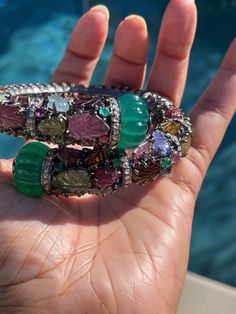 Custom stunning Bangle cuff with carved Aquamarine, Tourmaline, tanzanite gemstone leaf Gross Weight 76.6 Silver Rosecut Diamond 8.5carats Gemstones Tourmaline Aquamarine Tanzanite etc. 75.25carats Inv#122#5S800 Luxury Jeweled Bangle, Luxury Multi-stone Bangle As Gift, Luxury Multi-stone Bangle For Gift, Luxury Carved Bracelet Jewelry, Luxury Carved Bangle Jewelry, Luxury Natural Stones Bangle, Luxury Carved Bangle Bracelets, Luxury Carved Bangle Bracelet, Carved Emerald