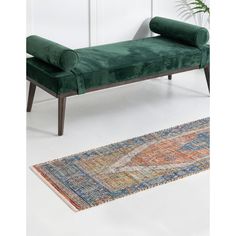 a green bench sitting on top of a rug