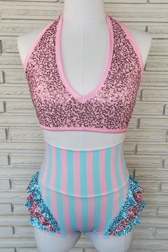 "This two piece sets includes a halter top with deep v-neck in ballet pink spandex with sequins. Wide under bust elastic, trimmed in pink stretch satin elastic keeps everything in place. Fully lined bust with removable foam cup inserts. The high waist briefs are nylon/spandex in 1/2\" ballet pink and aqua stripes with wide, double layer waistband. Hip flattering triple flounces at the leg line, finished off in self fabric binding. The briefs are a low, vintage style leg line and fully lined in b Fitted Sequin Halter Neck Top, Sequined Fitted Halter Neck Top, Pink Fitted Halter Neck Top, Pink Stretch Triangle Halter Top, Pink Triangle Halter Top For Party, Pink Dance Costumes, Aerial Costume, Pink Leotard, Dance Comp