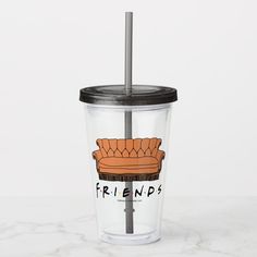 a plastic cup with a straw in the shape of a couch and friends logo on it