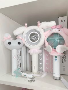 a shelf with various items on it including an electronic device and bunny earpieces