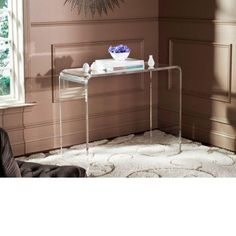 a clear console table in front of a window