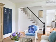 a living room filled with furniture and a stair case