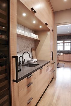 a kitchen with wooden cabinets and black counter tops