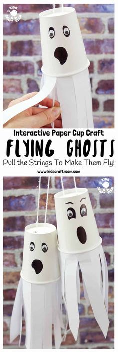 some paper cups that have been made to look like ghostes hanging from the ceiling