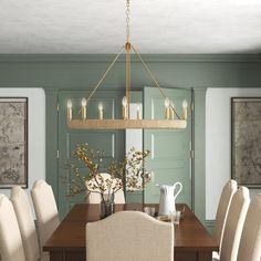 a dining room table with white chairs and a chandelier hanging from the ceiling