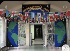 the entrance to an international school with flags hanging from it's walls and doors