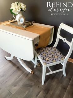 a white desk with a chair next to it and a sign that says refind design