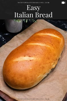 a loaf of bread sitting on top of a wooden cutting board