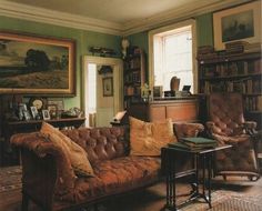 a living room filled with furniture and lots of books