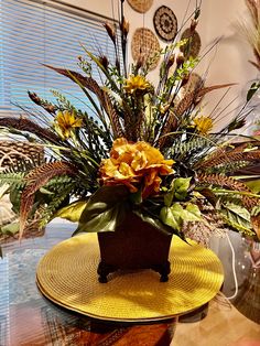 an arrangement of flowers in a vase on a table