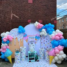 an ice cream parlor decorated with balloons and confetti for a birthday or baby shower