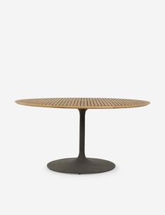 an oval wooden table with black base