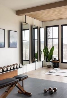 a living room filled with lots of windows and furniture