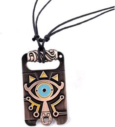 a necklace with an evil eye on the front and back of it, hanging from a cord