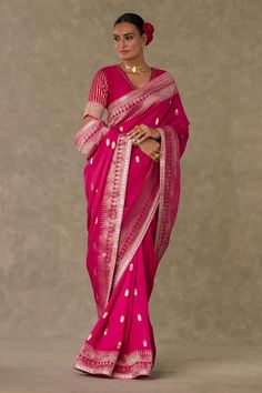 Magenta saree crafted in jacquard silk base with all over hath phool pattern, highlighted with trikone, anar zari border and edged with kinari. Comes along with an unstitched blouse fabric    embellished with embroidered border and gota silai work.
Components: 2
Pattern: Embroidery
Type Of Work: Haath Phool, Trikone, Anar Zari
Fabric: Saree: Jacquard silk, Blouse piece: Silk
Color: Magenta
Other Details: 

Note: The stitched blouse worn by the model is not for sale
Disclaimer: The actual print-p Haath Phool, Caribbean Fashion, House Of Blouse, Brocade Saree, Embroidered Border, Red Saree, Lakme Fashion Week, Indian Fashion Designers, Silk Embroidery