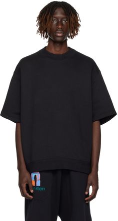 Heavyweight cotton- and polyester-blend French terry T-shirt. · Rib knit mock neck and hem · Dropped shoulders · Raglan sleeve-style piping at back Supplier color: Black beauty Calvin Klein Clothing, Calvin Klein Outfits, Mock Neck And T Shirt, Fashion Design Template, Black Mock Neck, Photoshoot Inspo, Calvin Klein Black, Black Beauty, Black Shorts