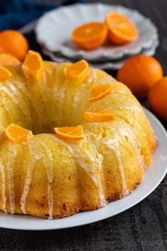 a bundt cake with oranges on the side