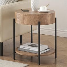 a wooden table with two black legs and a white vase on the end shelf next to it