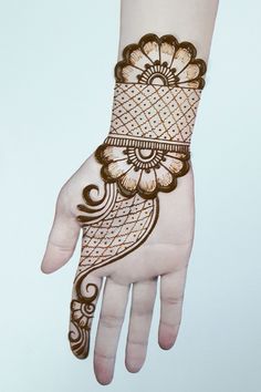 the hand is decorated with henna designs