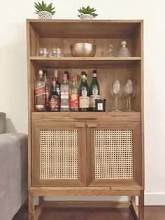 a wooden cabinet filled with bottles and glasses