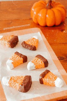 several pieces of cake sitting on top of a cutting board with marshmallows