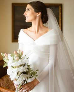 a woman in a wedding dress holding a bouquet