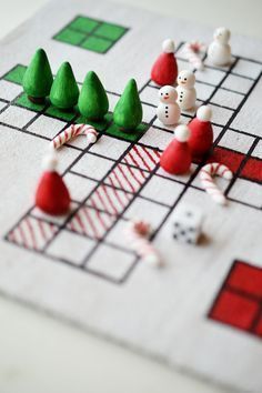 a close up of a board game with snowmen on it and candy canes