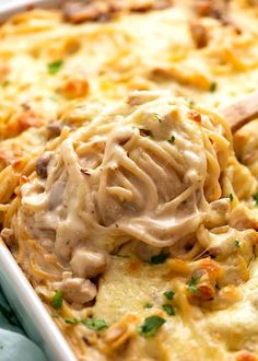 a casserole dish filled with chicken and noodles, topped with gravy