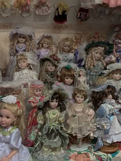 there are many dolls on display in this room together, all dressed up and ready to be sold