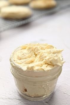 a jar filled with cream sitting on top of a table