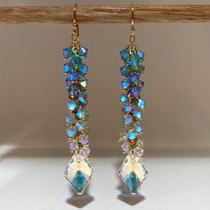 These eye catching, meticulously handcrafted earrings where made using authentic, ultra mint condition Swarovski Crystals, carefully wrapped with 14k Gold Filled ball pins Ombre Style attached to 14k gold filled chain and ear wire.  Composed with 4mm Light Turquoise Aurora Borealis 2X, Light Sapphire AB2X, Air Blue Opals AB2X, Clear Shimmery Crystals and gorgeous Swarovski Pendants to create a magical effect that is truly mesmerizing.  *They look SPECTACULAR during the day and are more than perfect for many occasions.  *They can be that something blue for your wedding.  * Upgrade any casual look with these gorgeous pair of earrings. I guarantee you will be complimented. Length: 3 inch drop Width: 10-12mm Message me if you want this style in a different length, if you need more quantities o Blue Opal Jewelry, Swarovski Pendant, Ombre Fashion, Light Sapphire, Earring Ideas, Light Turquoise, Handcrafted Earrings, Jewelry For Her, Opal Jewelry