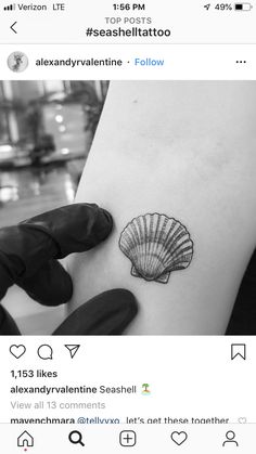 a small tattoo on the back of a woman's left arm, with a sea shell