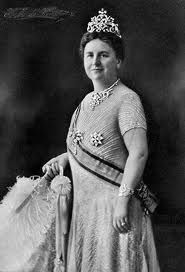 an old black and white photo of a woman wearing a tiara