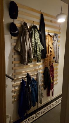 a coat rack with hats and coats hanging on it