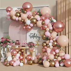 a pink and gold birthday party with balloons