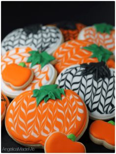 decorated cookies with pineapples and carrots on them are arranged in the shape of pumpkins