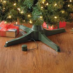 a christmas tree stand with presents under it