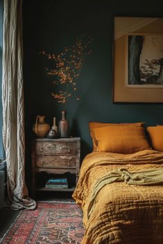 a bedroom with dark green walls and yellow bedding, an orange blanket on top of the bed