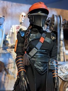 a star wars cosplay dressed in black and orange