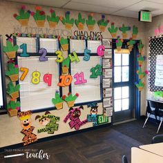 a bulletin board with numbers and plants on it in an office classroom decorated for the school year