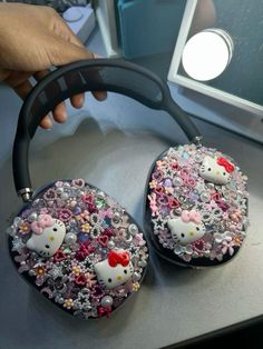 two hello kitty purses are sitting on a table