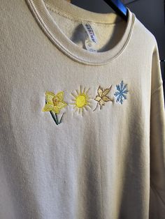 a t - shirt with flowers embroidered on it